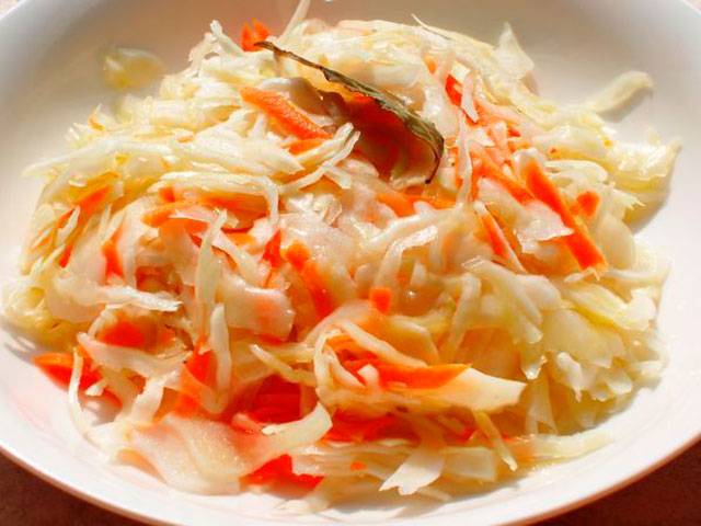 Pickled cabbage in jars with vinegar