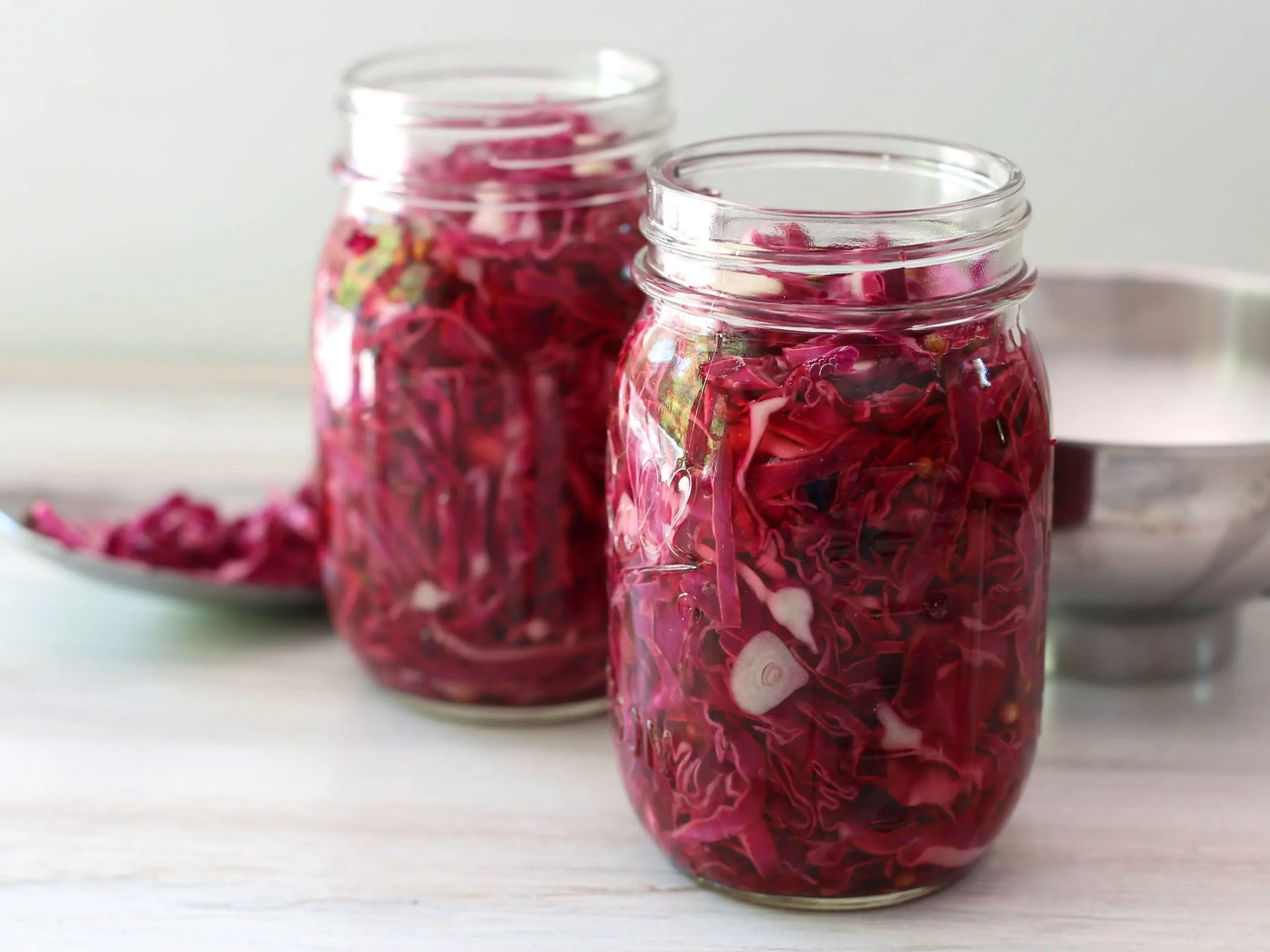 Pickled cabbage in jars with vinegar