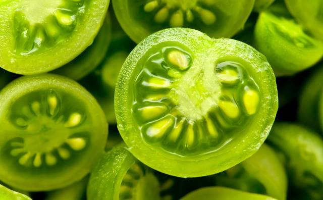 Pickled green tomatoes with hot peppers