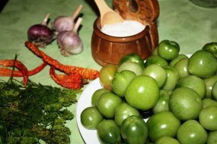 Pickled green tomatoes with hot peppers