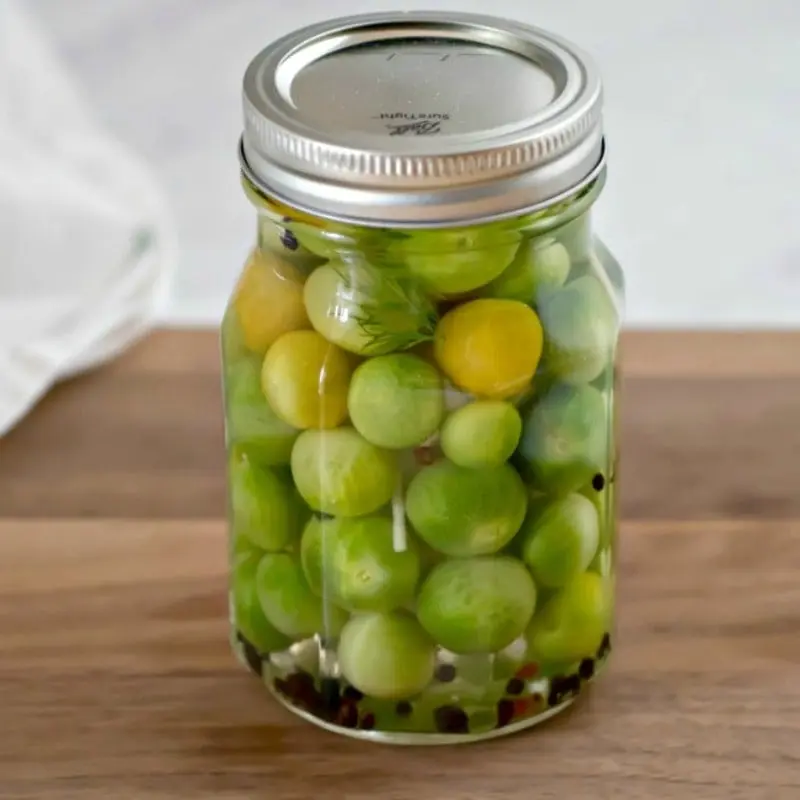 Pickled instant green tomatoes in a pot