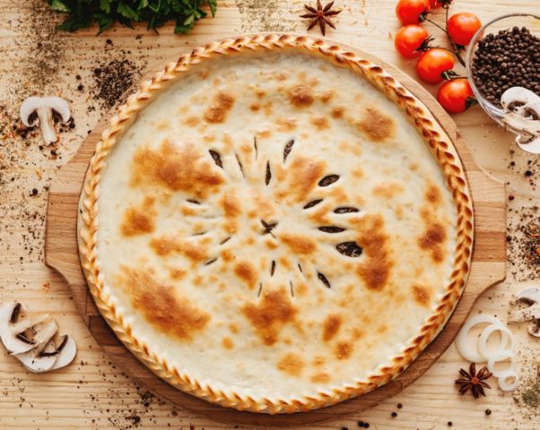 Pie with mushrooms mushrooms in the oven from puff and yeast dough