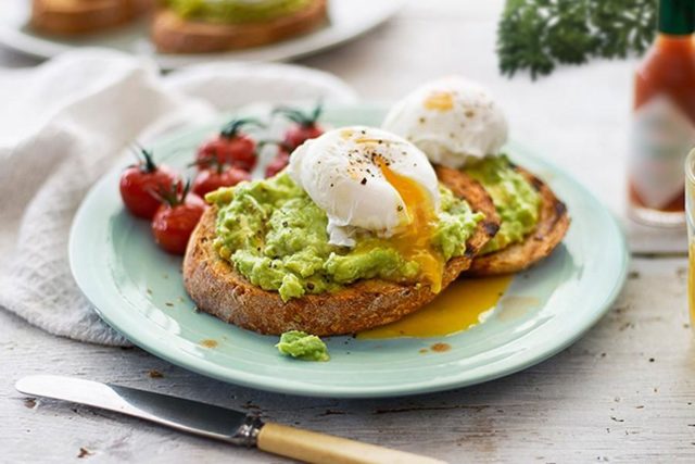 Sandwiches with avocado and red fish, eggs, cheese