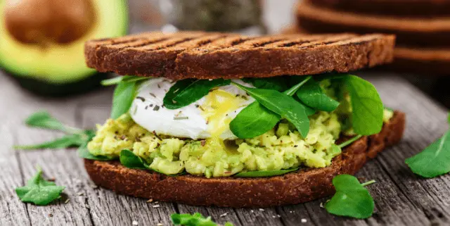 Sandwiches with avocado and red fish, eggs, cheese