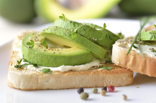 Sandwiches with avocado and red fish, eggs, cheese