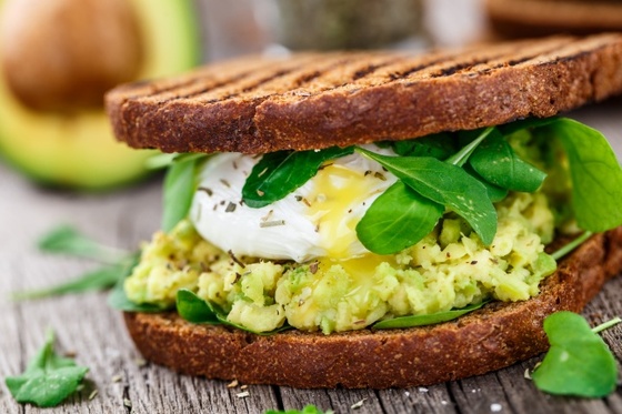 Sandwiches with avocado and red fish, eggs, cheese