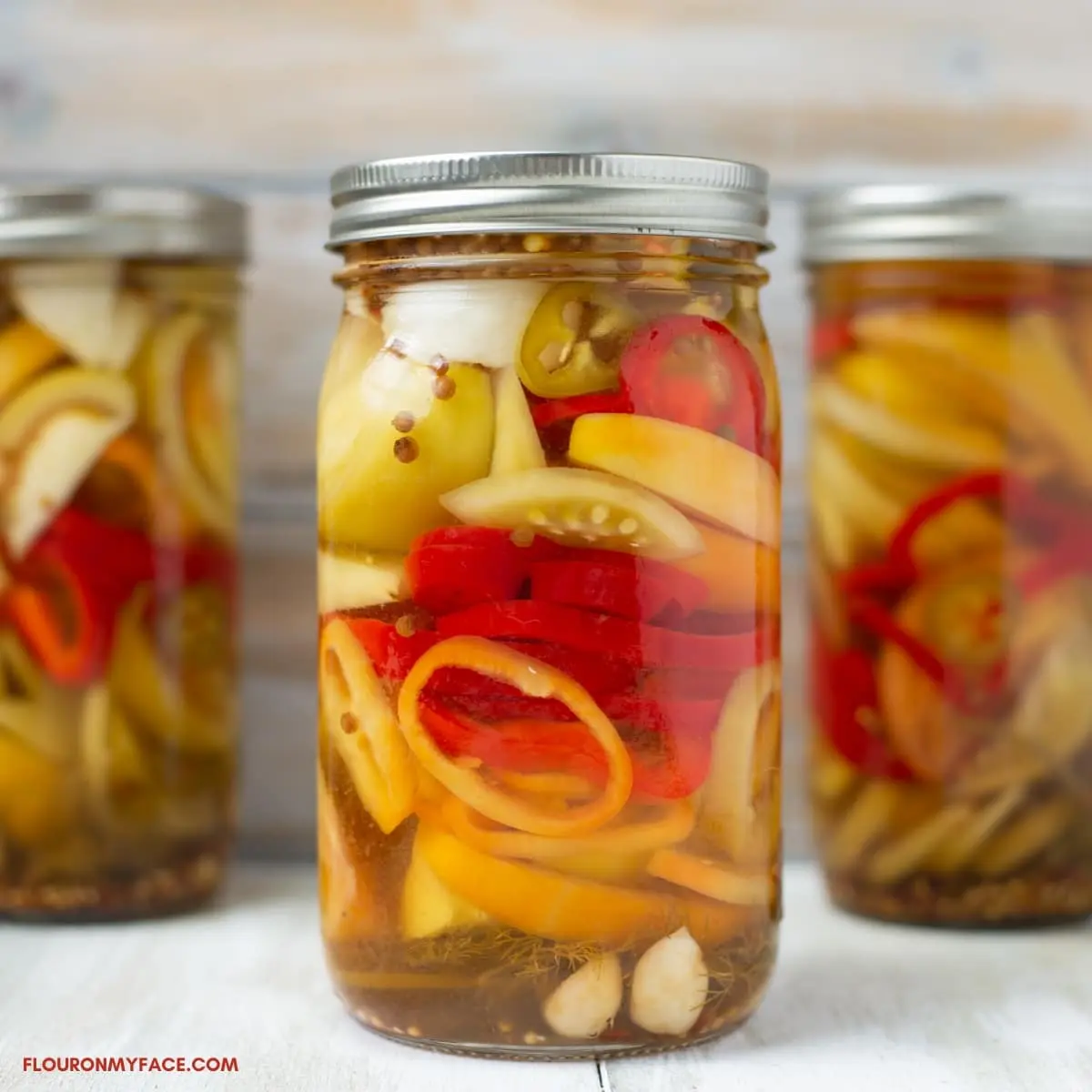 Sliced ​​marinated green tomatoes with hot peppers