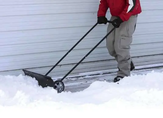 Snow scraper on wheels