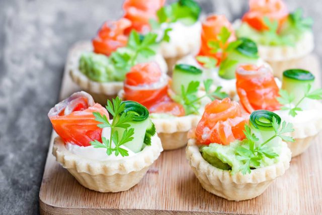 Tartlets with avocado and shrimps, cheese, fish