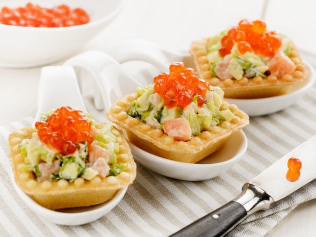 Tartlets with avocado and shrimps, cheese, fish