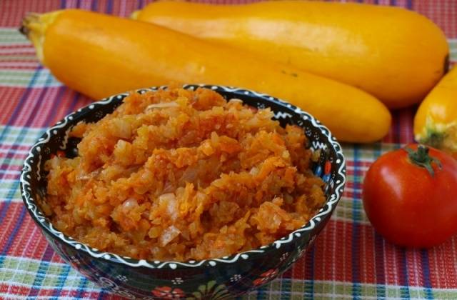 Zucchini caviar in a frying pan with cubes