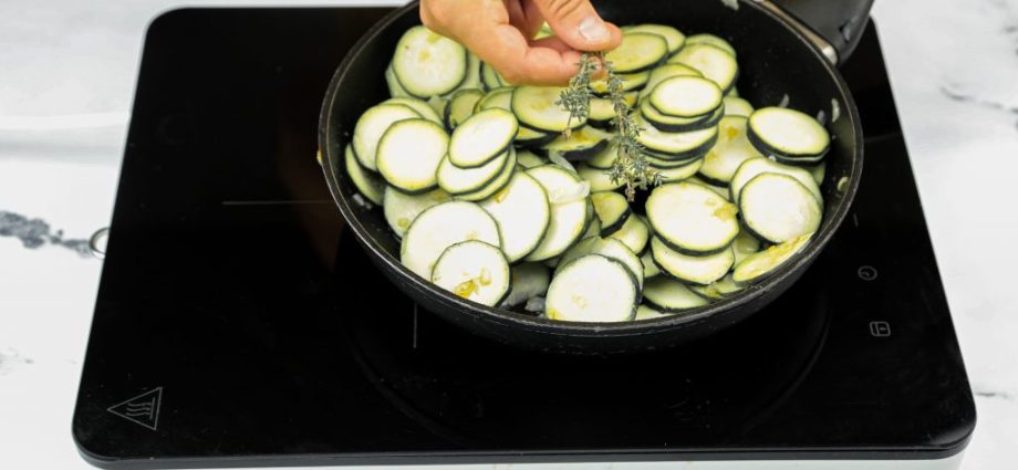 Zucchini caviar in a frying pan with cubes