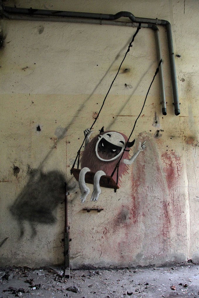 An artist draws monsters on the walls of abandoned buildings in Berlin