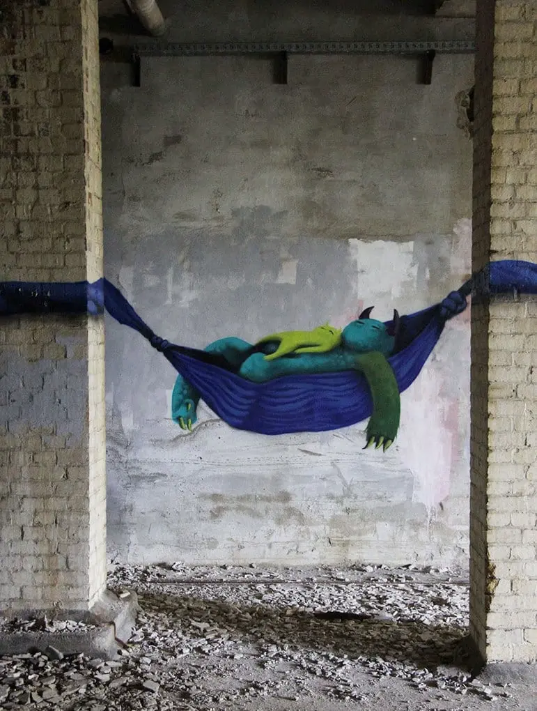 An artist draws monsters on the walls of abandoned buildings in Berlin