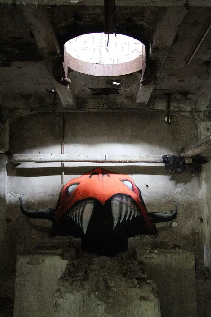 An artist draws monsters on the walls of abandoned buildings in Berlin