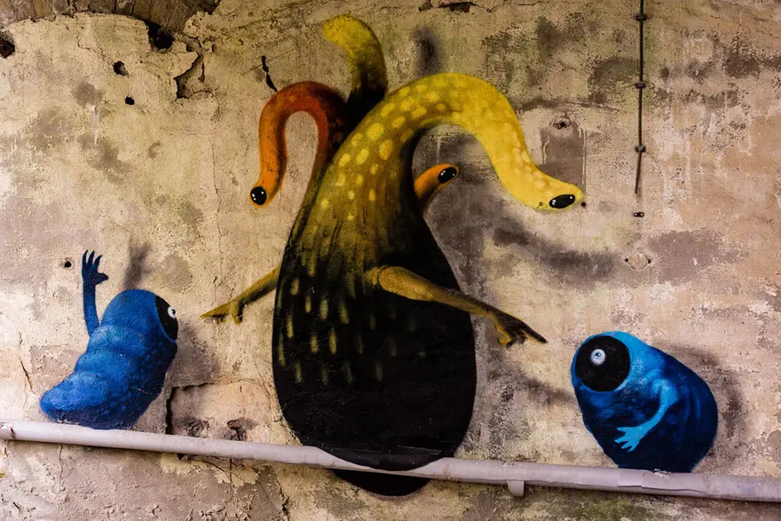 An artist draws monsters on the walls of abandoned buildings in Berlin