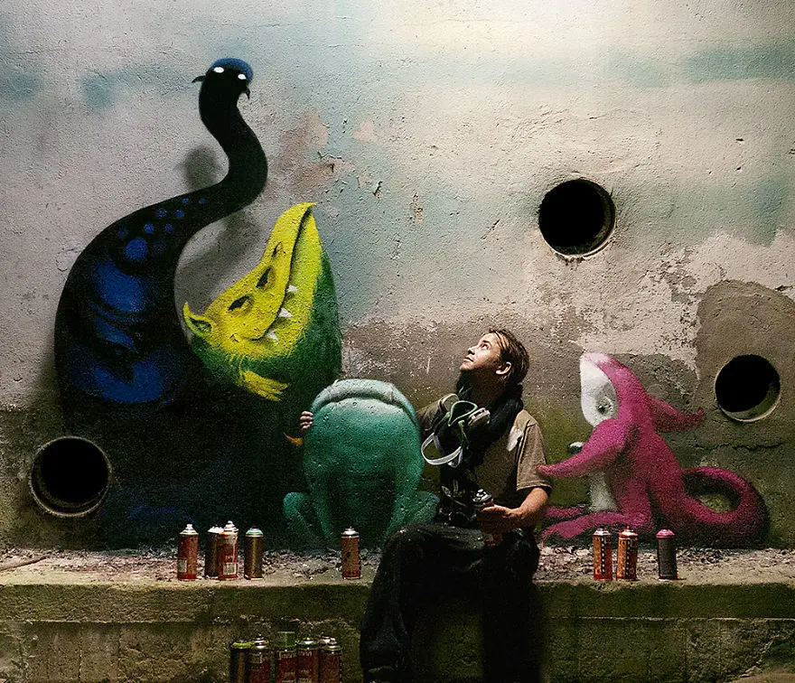 An artist draws monsters on the walls of abandoned buildings in Berlin